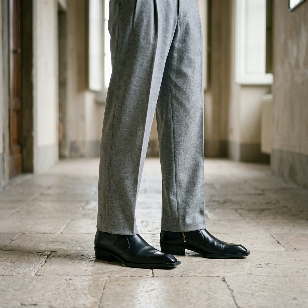 Black leather Levante zipper boots worn with grey flannel trousers
