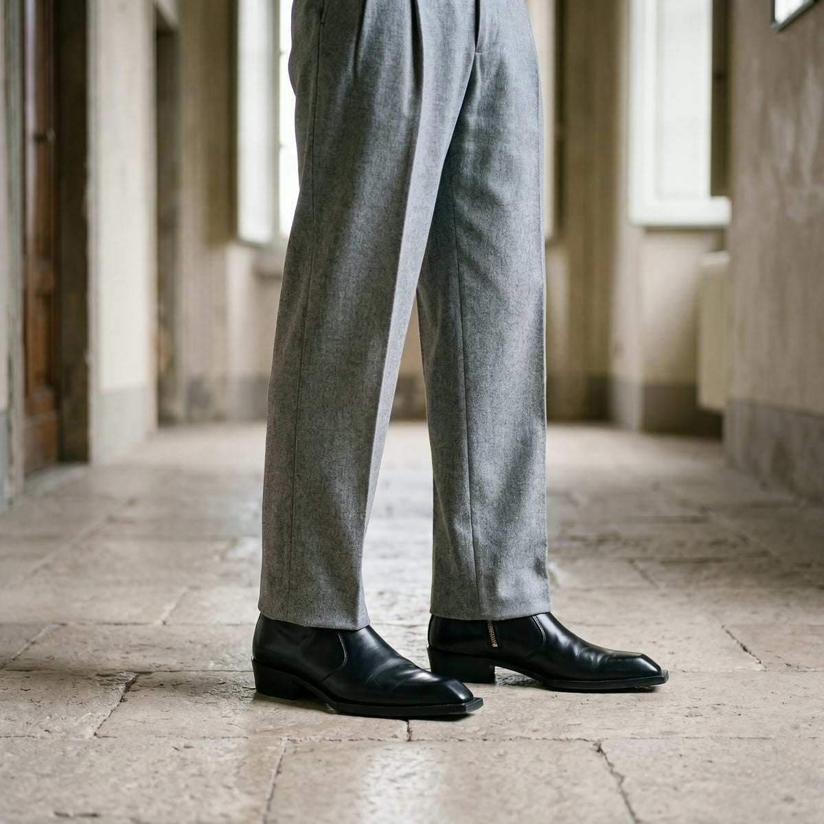 Black leather Levante zipper boots worn with grey flannel trousers