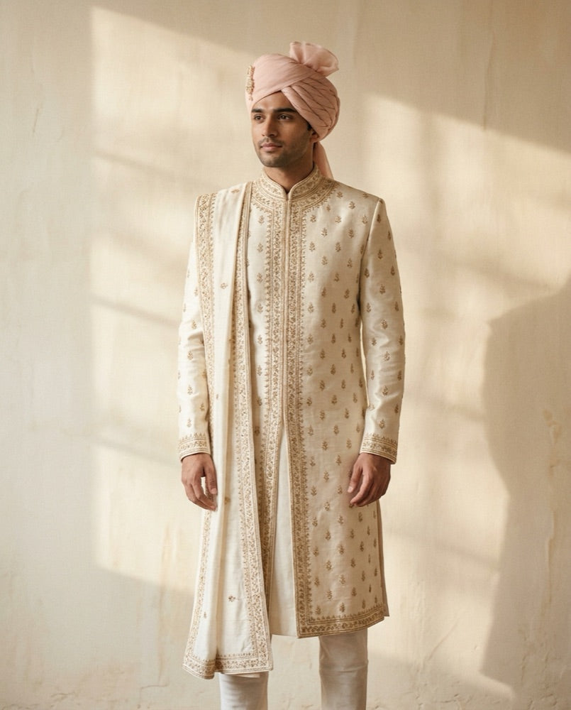 Groom in an ivory embroidered sherwani with a blush safa